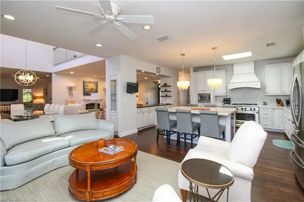 a living room with furniture and kitchen view