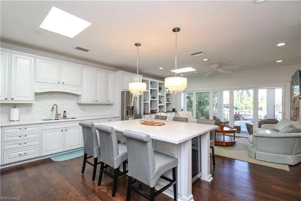 a large kitchen with a table and chairs