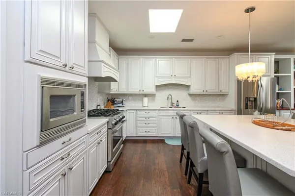 a kitchen with a stove window and cabinets