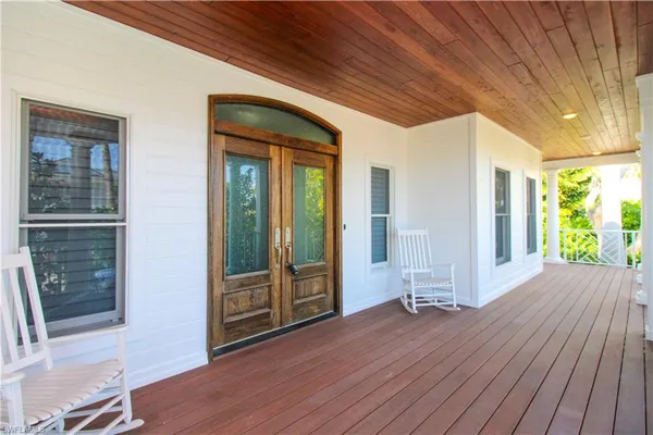a view of outdoor space with wooden floor and windows
