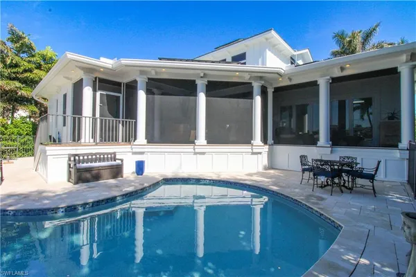 a view of a patio with table and chairs