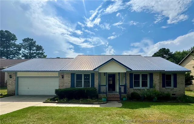 a front view of a house with a garden and plants