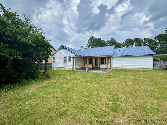 a front view of a house with a garden and yard