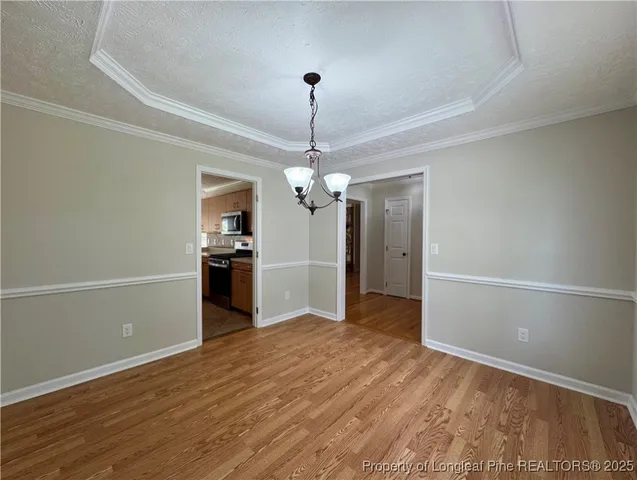 a view of a kitchen with a sink and a chandelier