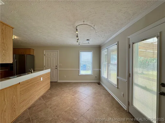 a large room with a large window and furniture