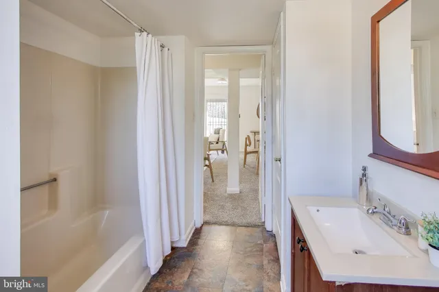 a bathroom with a sink a mirror and a bathtub