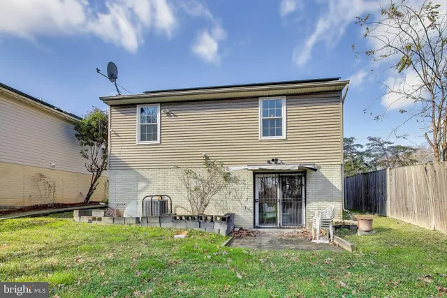 a backyard of a house with garden and barbeque oven
