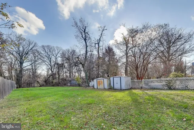 a front view of a house with garden and tree