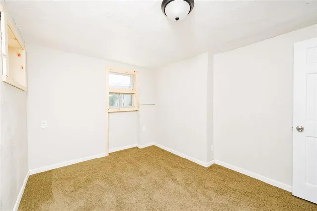 a view of a room with wooden floor and cabinet