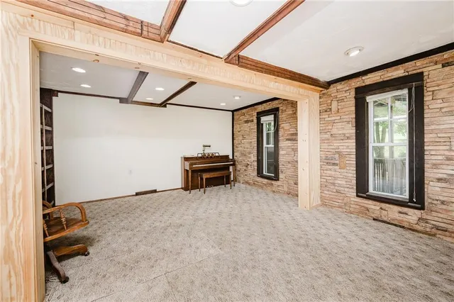 a view of an empty room with furniture and floor to ceiling window