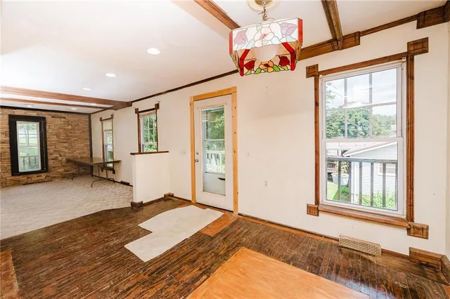 a spacious bedroom with a bed and a window