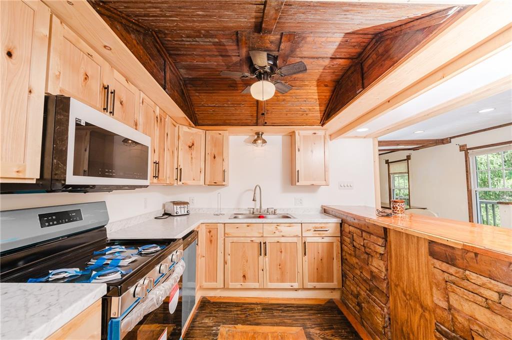 150 Penn Street Clymer, PA 15728 - Photo 25 of 38 a kitchen with stainless steel appliances a stove a sink and a microwave