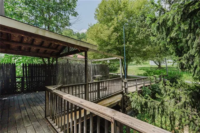 a view of a wooden deck with a backyard