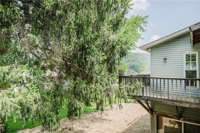 a view of balcony with outdoor seating and trees
