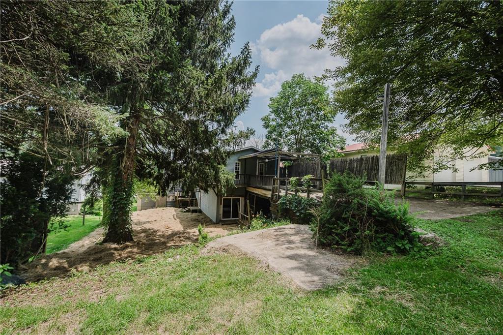 150 Penn Street Clymer, PA 15728 - Photo 37 of 38 a view of a backyard with couches plants and large trees