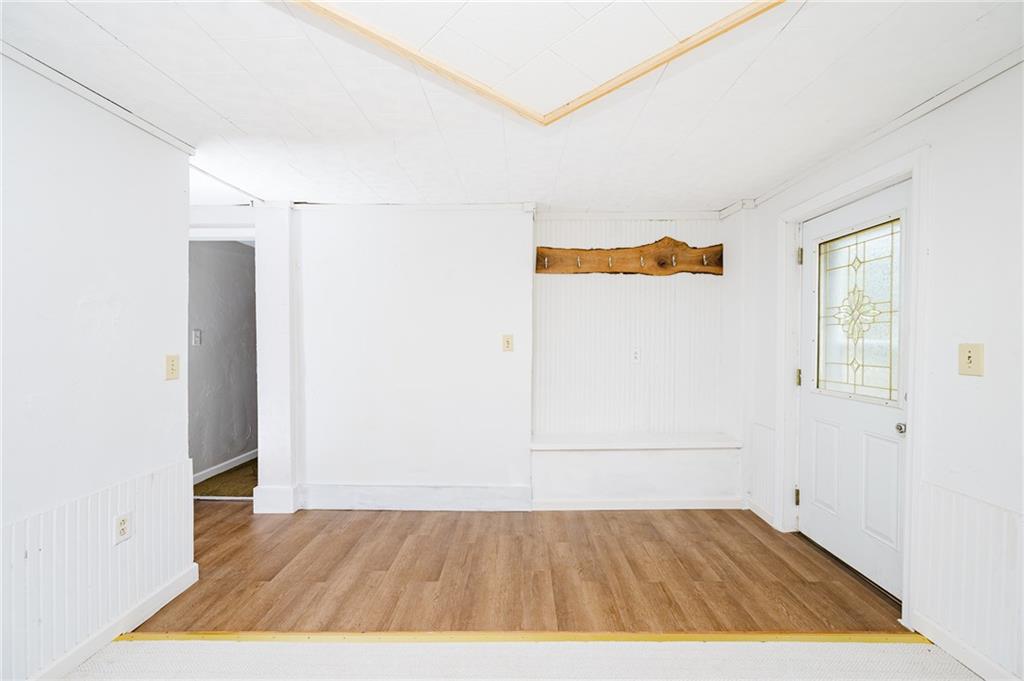 150 Penn Street Clymer, PA 15728 - Photo 4 of 38 an empty room with wooden floor and windows