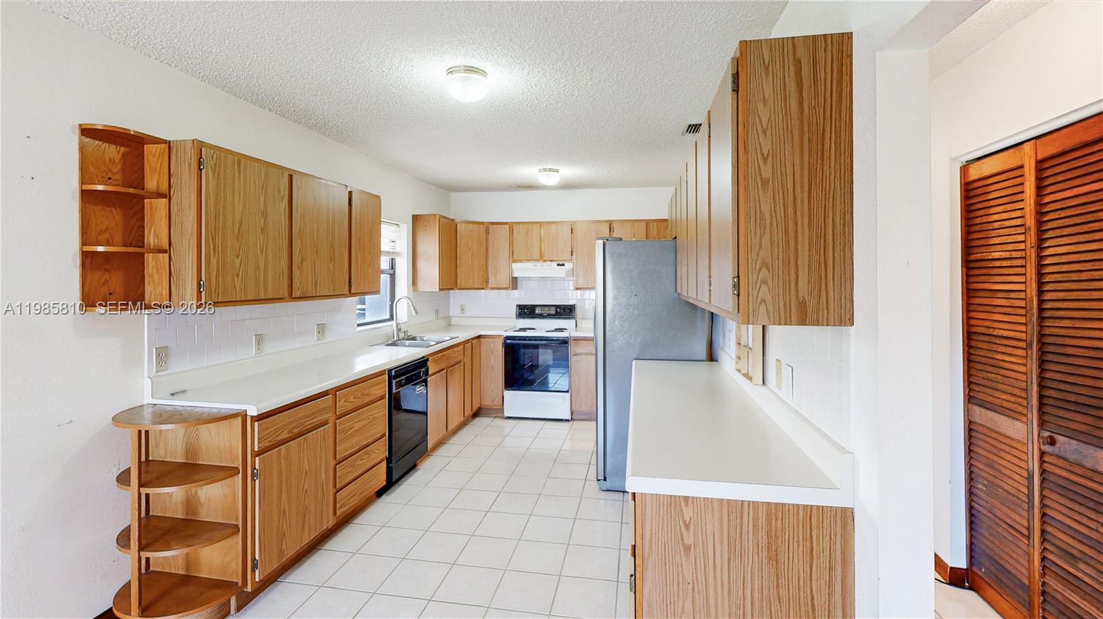 14380 Southwest 297th Street Homestead, FL 33033 - Photo 17 of 62 a large kitchen with stainless steel appliances granite countertop a stove a sink and a refrigerator