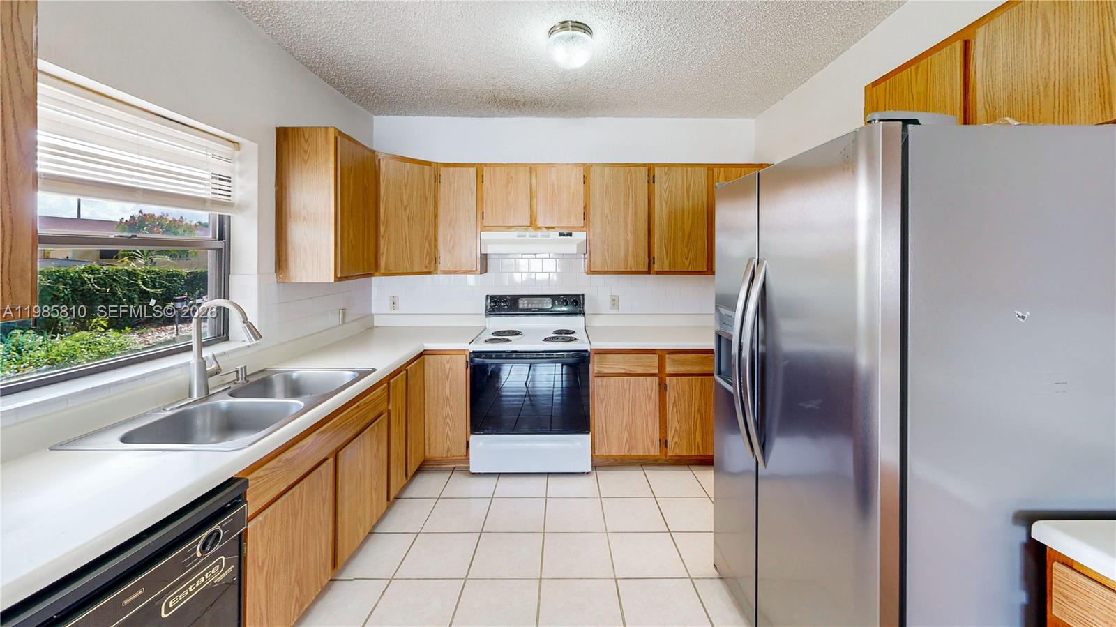 14380 Southwest 297th Street Homestead, FL 33033 - Photo 18 of 62 a kitchen with stainless steel appliances granite countertop a refrigerator and a sink