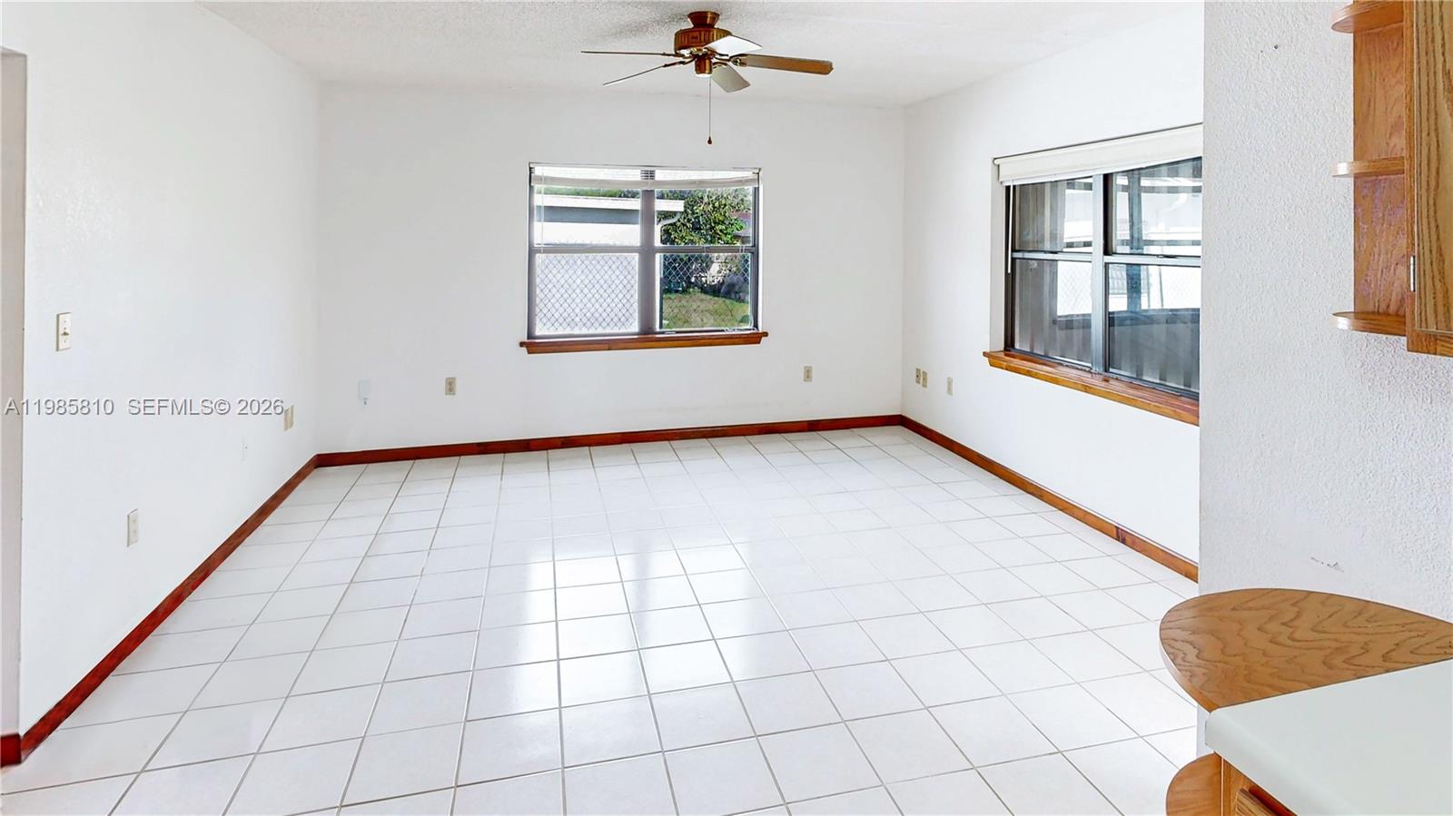 14380 Southwest 297th Street Homestead, FL 33033 - Photo 20 of 62 an empty room with windows and chandelier fan