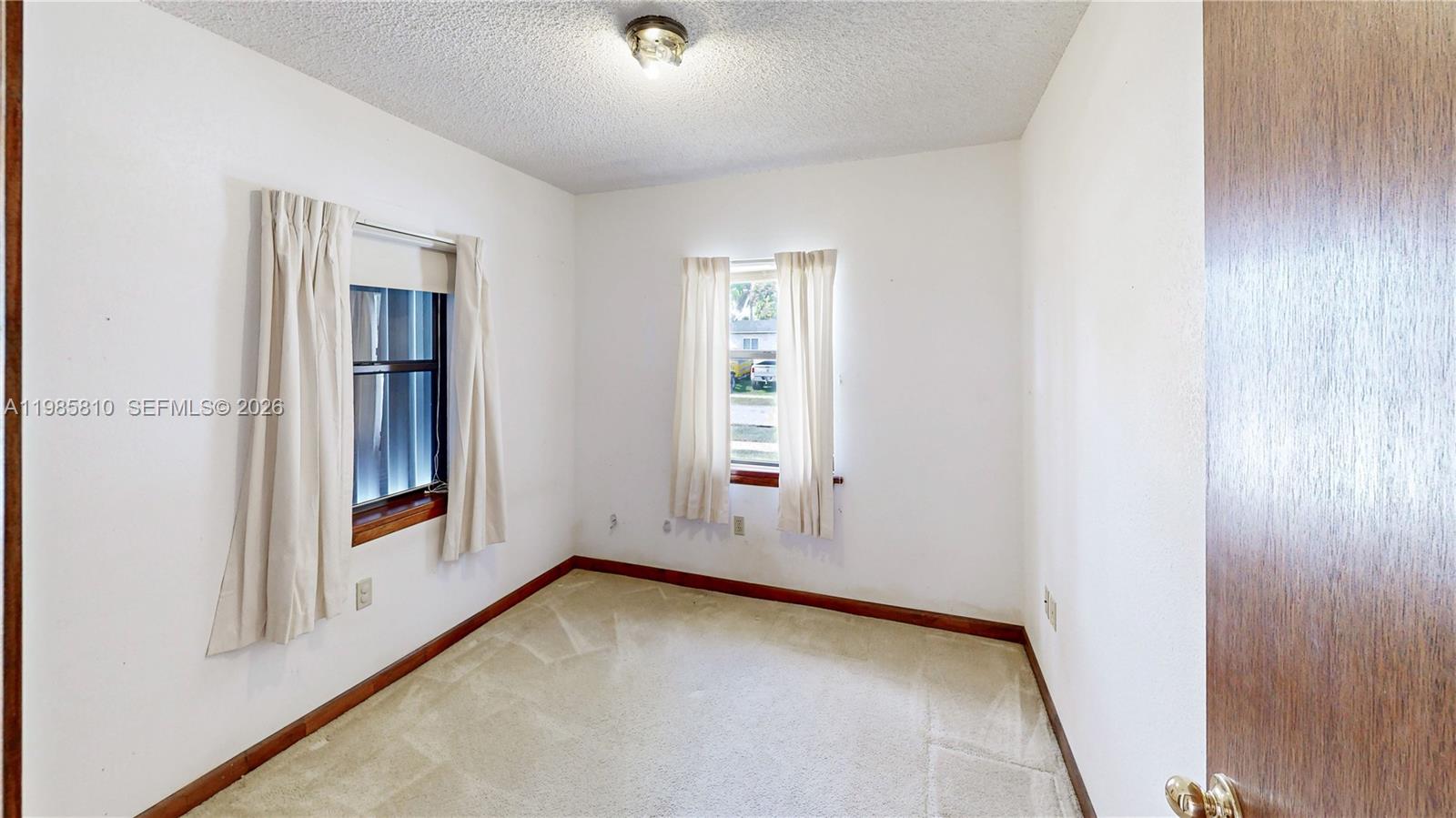 14380 Southwest 297th Street Homestead, FL 33033 - Photo 31 of 62 an empty room with windows