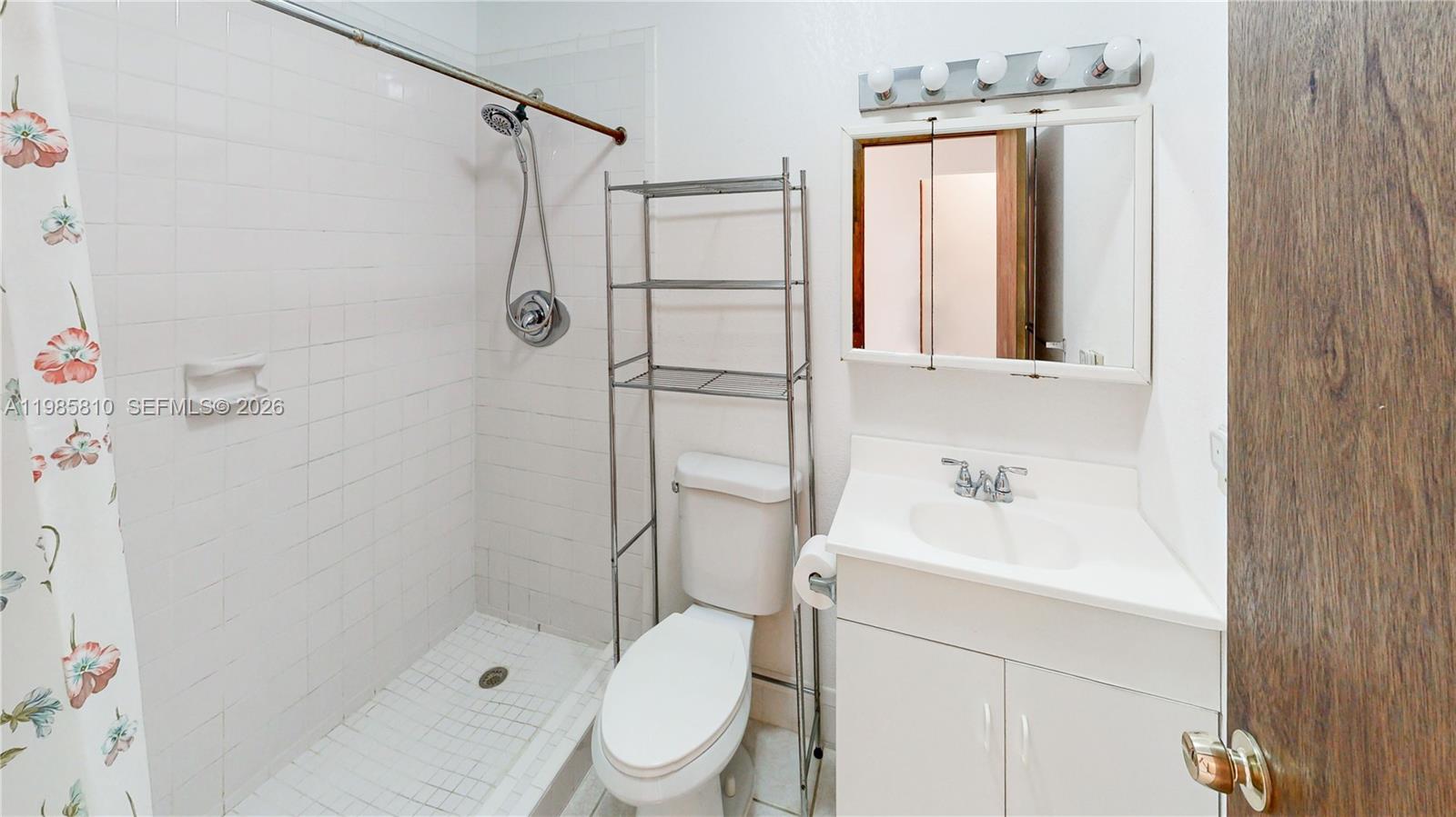 14380 Southwest 297th Street Homestead, FL 33033 - Photo 34 of 62 a bathroom with a sink a toilet and shower