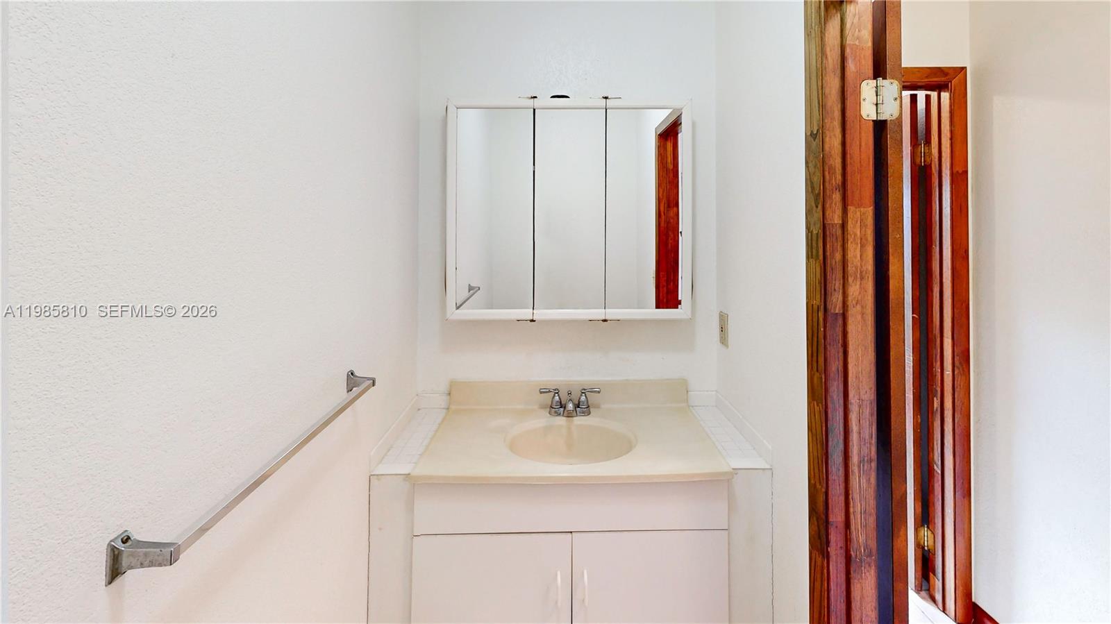 14380 Southwest 297th Street Homestead, FL 33033 - Photo 39 of 62 a bathroom with a sink and a mirror