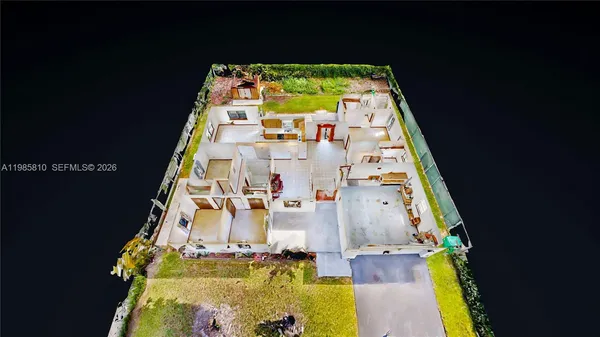 an aerial view of multiple houses with a yard