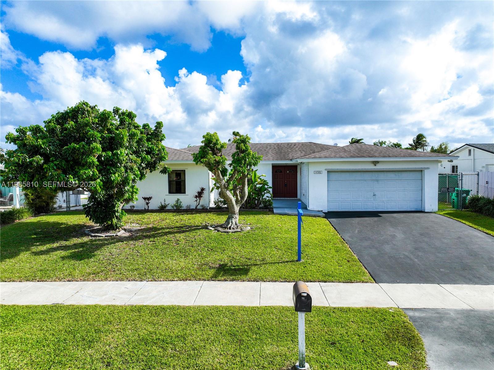 14380 Southwest 297th Street Homestead, FL 33033 - Photo 50 of 62 a front view of a house with garden