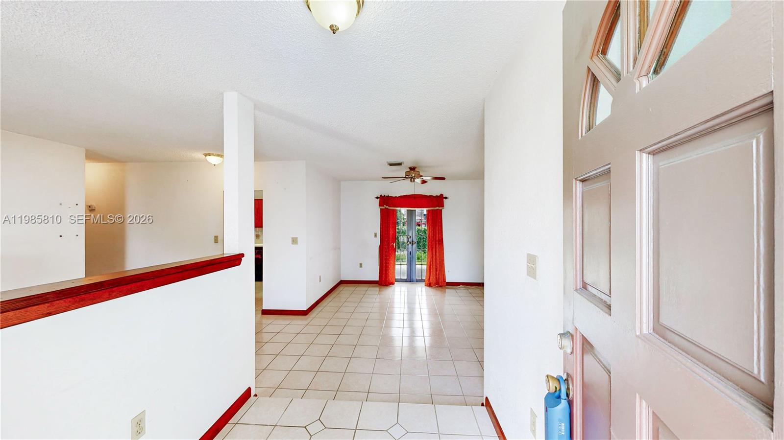 14380 Southwest 297th Street Homestead, FL 33033 - Photo 5 of 62 a view of an entryway with wooden floor and door
