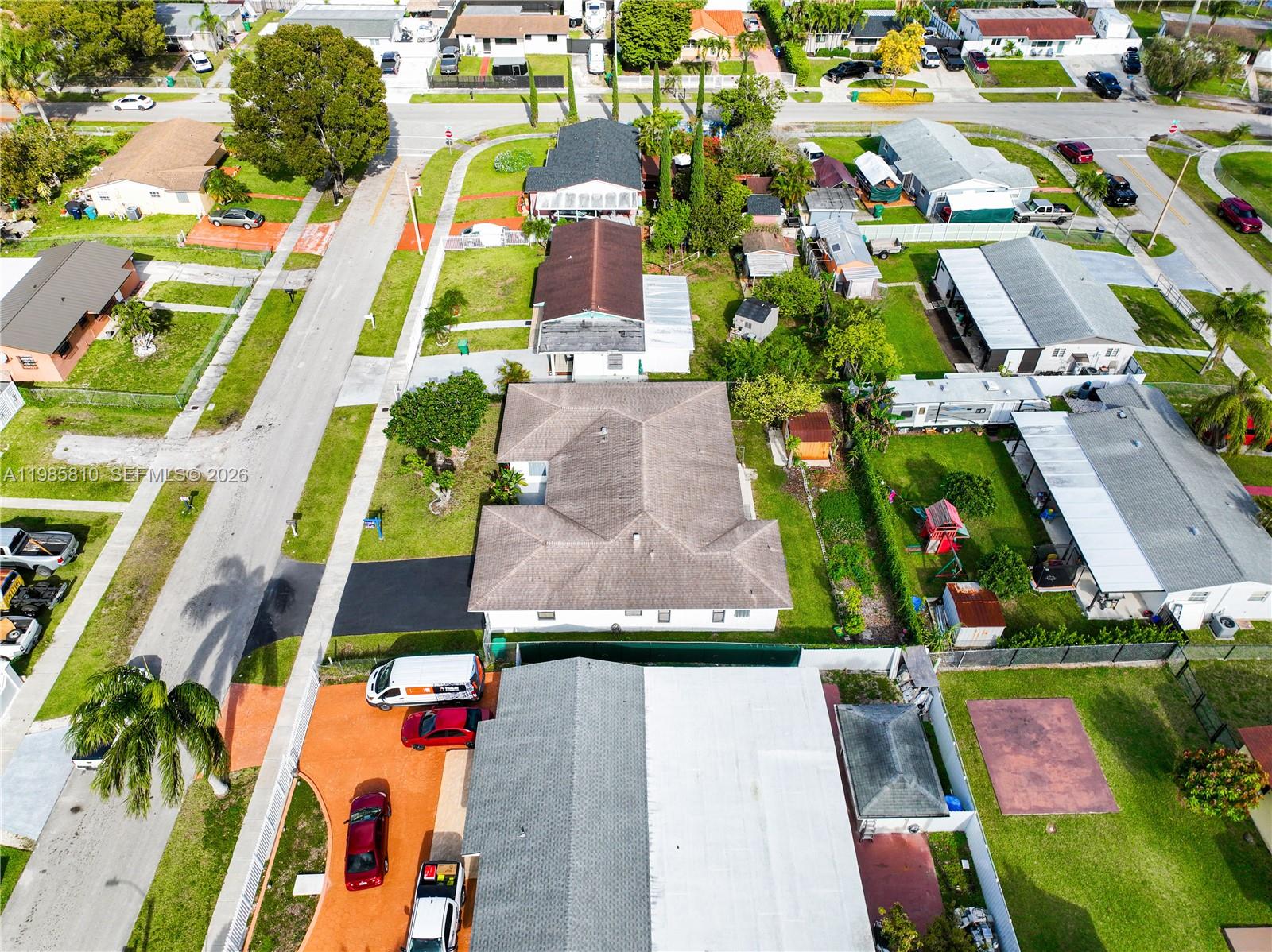 14380 Southwest 297th Street Homestead, FL 33033 - Photo 58 of 62 an aerial view of multiple houses with a yard