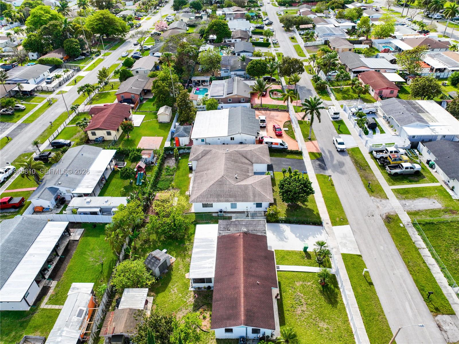 14380 Southwest 297th Street Homestead, FL 33033 - Photo 59 of 62 an aerial view of multiple houses with yard