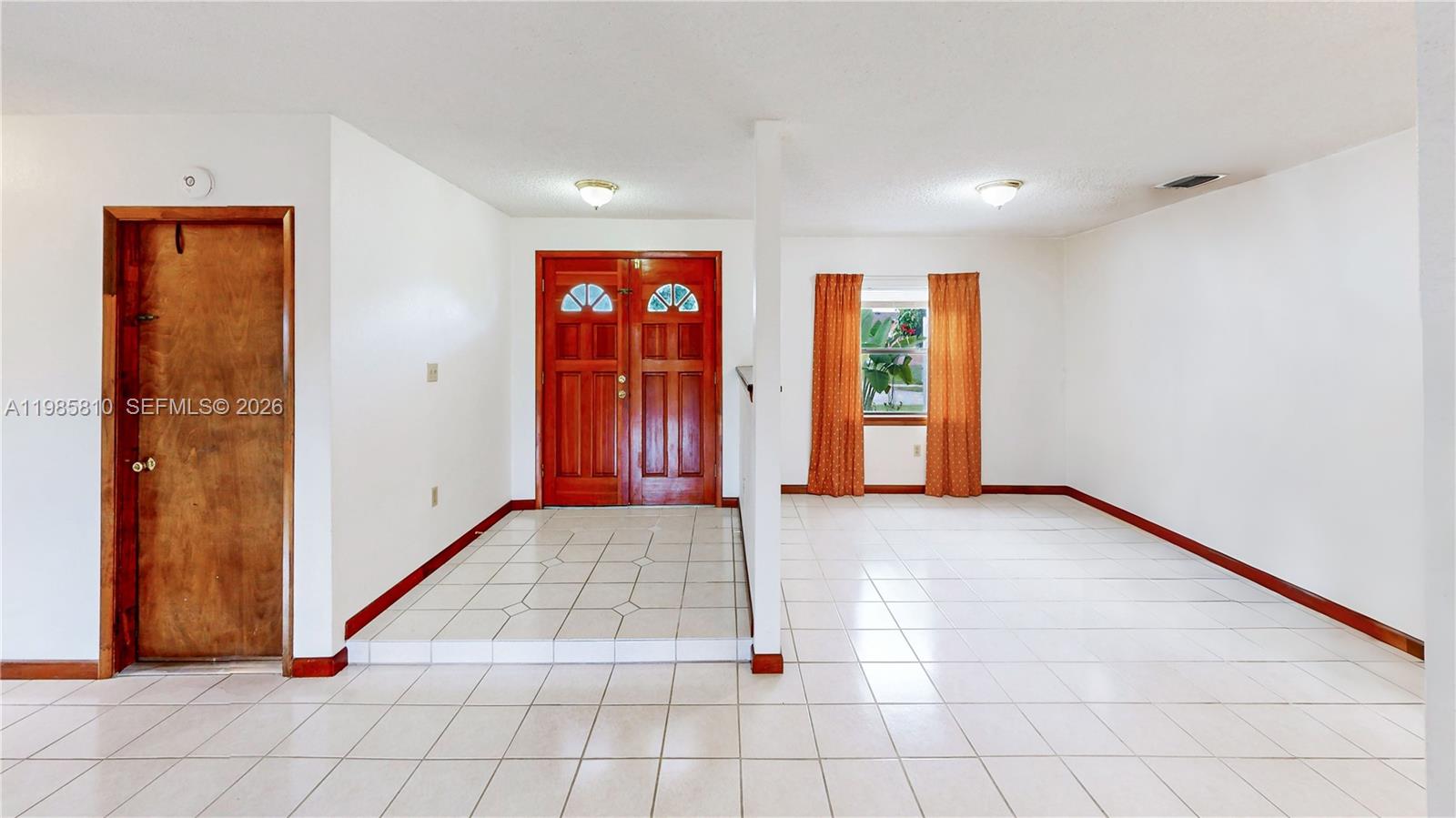 14380 Southwest 297th Street Homestead, FL 33033 - Photo 6 of 62 a view of an empty room with window and chandelier