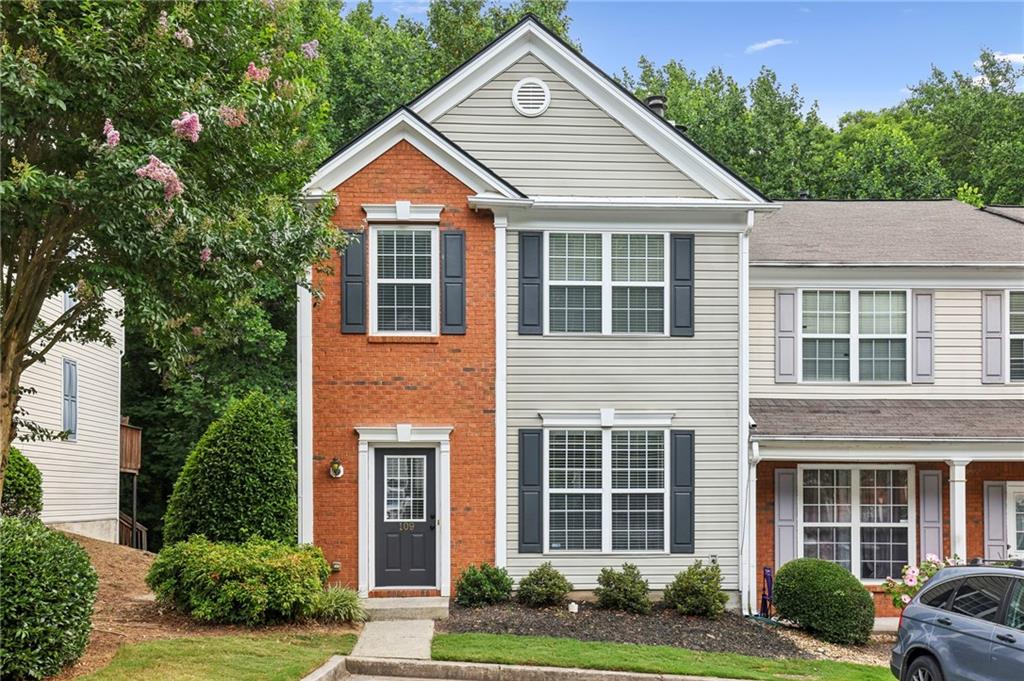 9155 Nesbit Ferry Road, Unit 109 Alpharetta, GA 30022 - Photo 1 of 1 a view of a brick house with plants and windows