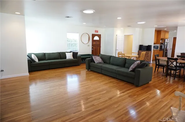 a kitchen with kitchen island granite countertop wooden cabinets stainless steel appliances a sink and a window