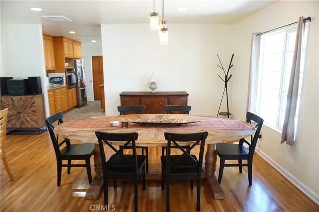 a kitchen with stainless steel appliances granite countertop a stove a sink and a refrigerator with wooden cabinets