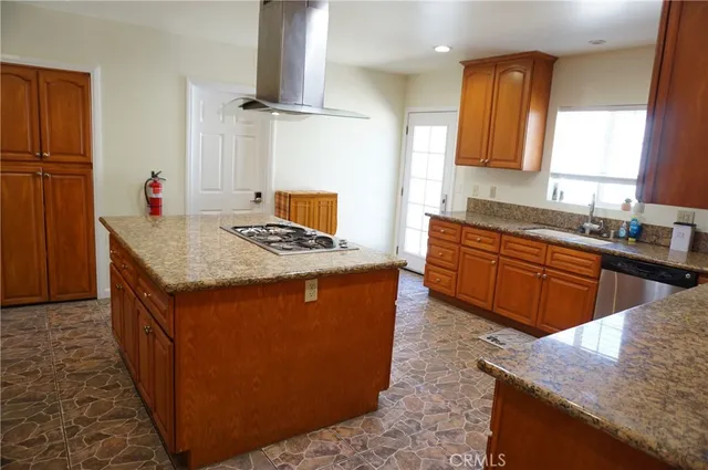 a bedroom with a bed chandelier and a window