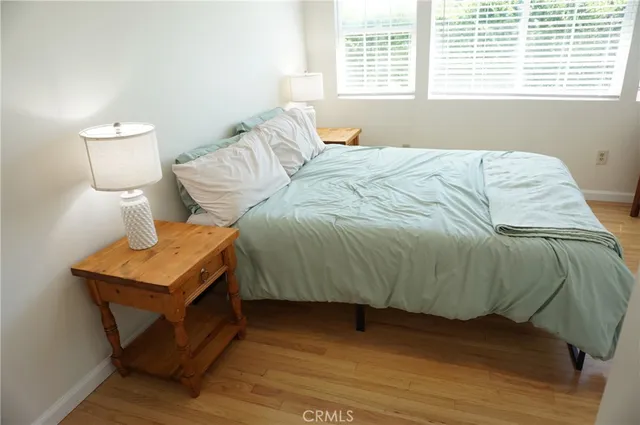 a bed sitting in a bedroom next to a small yard