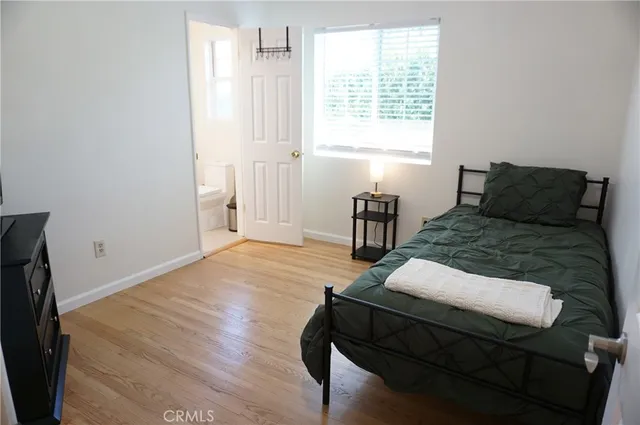 a room with a bed and flat screen tv