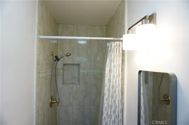 a living room with furniture a rug and a floor to ceiling window