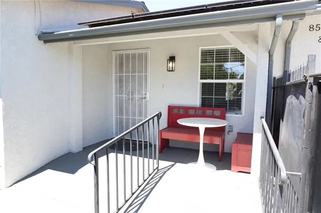 a living room with furniture wooden floor and a large window