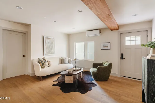 a living room with furniture rug and window