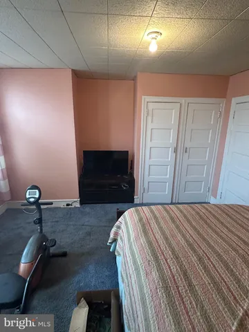 a room with bed and wooden floor