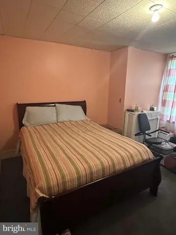 a bedroom with bed and window