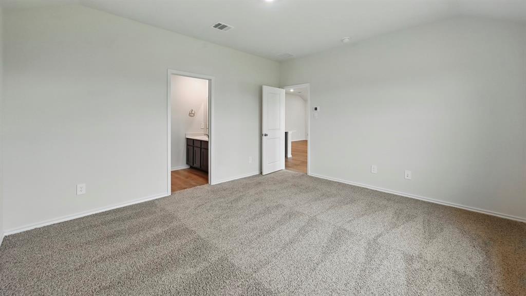 506 Lantana Road Princeton, TX 75407 - Photo 14 of 35 a view of a big room with closet and wooden floor