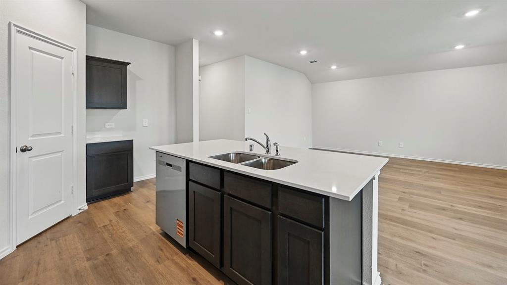 506 Lantana Road Princeton, TX 75407 - Photo 21 of 35 a kitchen with a sink cabinets and a wooden floor