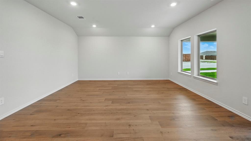 506 Lantana Road Princeton, TX 75407 - Photo 30 of 35 an empty room with wooden floor and windows