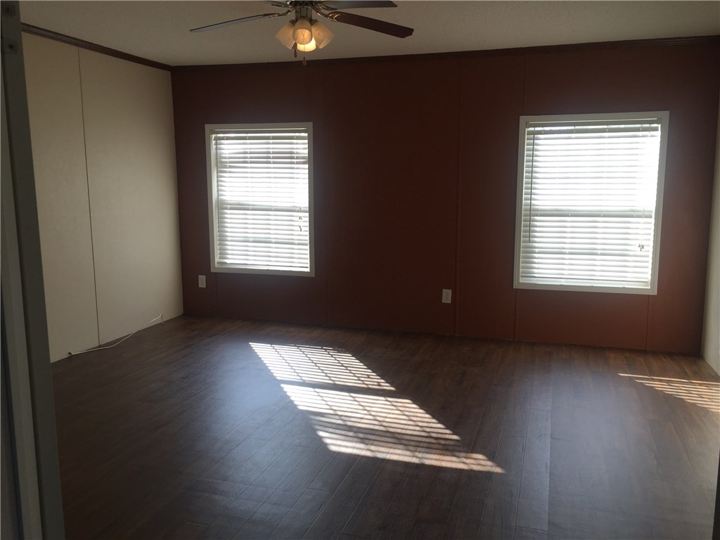 35611 Quail Road Callahan, FL 32011 - Photo 11 of 22 an empty room with wooden floor and windows