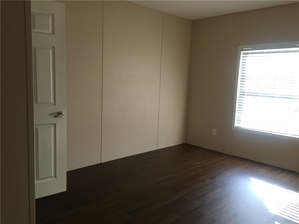 35611 Quail Road Callahan, FL 32011 - Photo 17 of 22 an empty room with wooden floor and windows