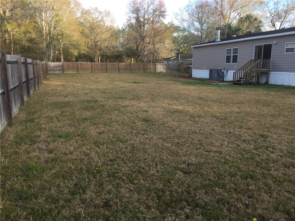 35611 Quail Road Callahan, FL 32011 - Photo 21 of 22 a view of a yard with a house and a tree