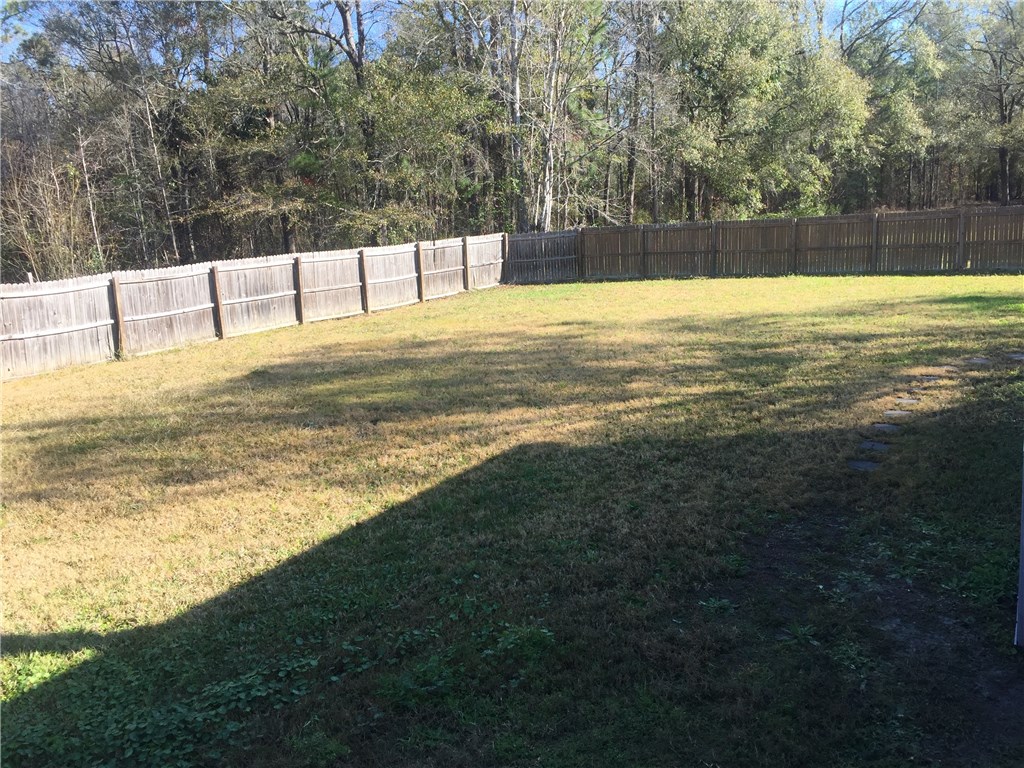 35611 Quail Road Callahan, FL 32011 - Photo 22 of 22 a view of a swimming pool with an outdoor seating and a yard